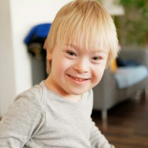 A smiling young boy with Down syndrome